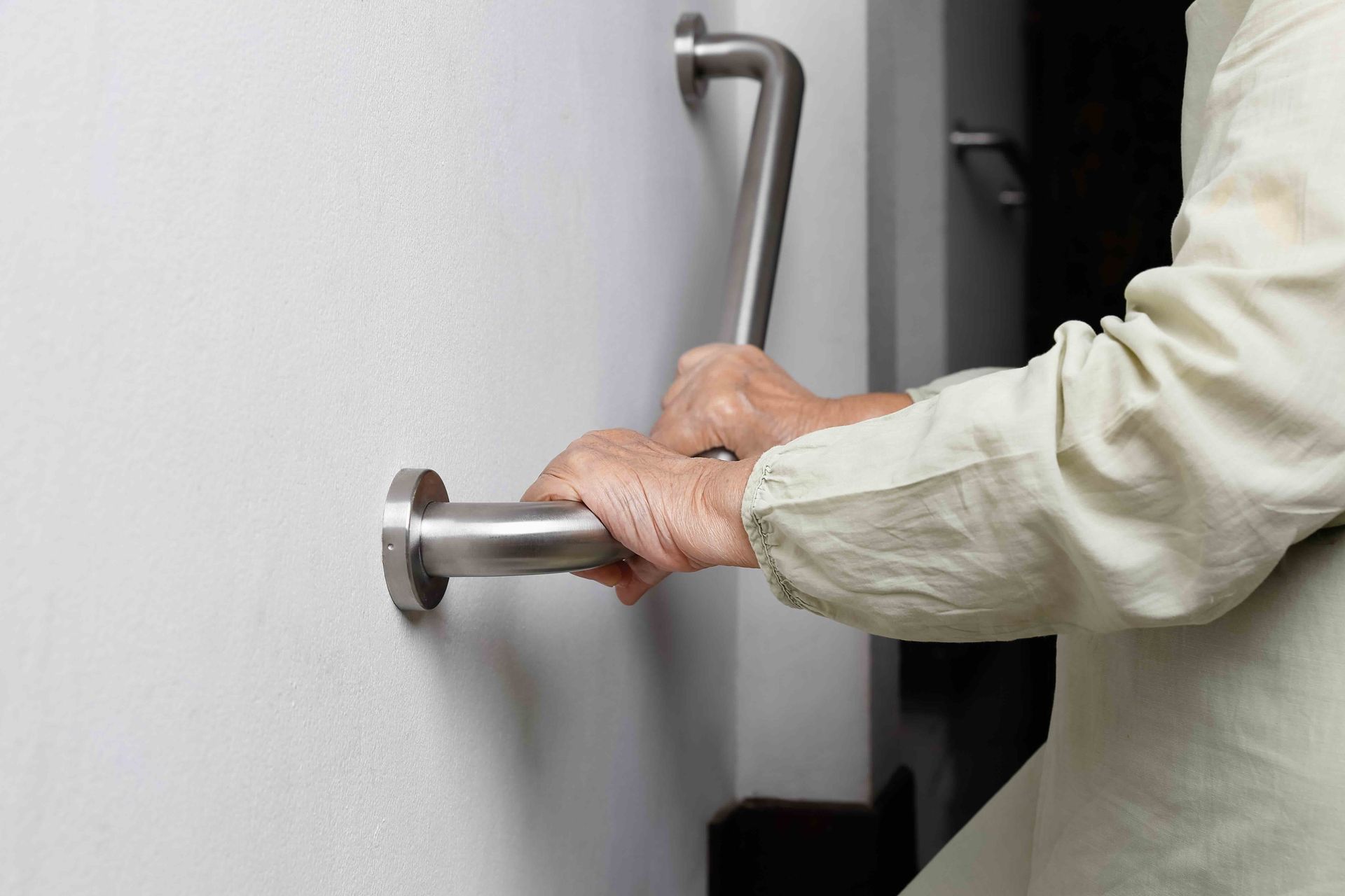 Homeowner using a professionally installed grab bar for safe, independent living
